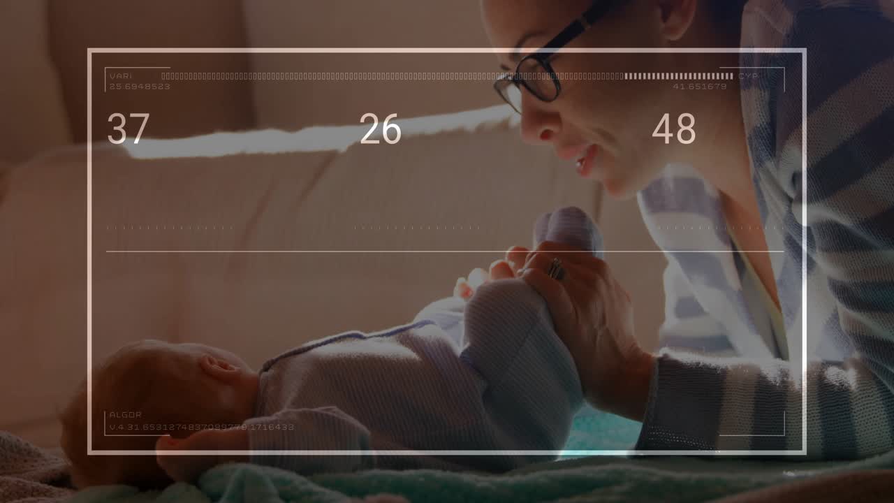 Mother lifting and kissing baby's foot on couch causing health metrics overlay showing fluctuations