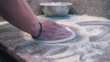 the pizza dough is formed and kneaded