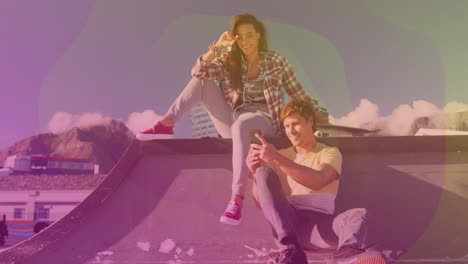 two friends relaxing on skate ramp, viewing smartphone screen with floating tech icons and graphs