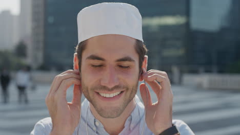 portrait attractive young arab student man puts on earphones enjoying listening to music in relaxed urban city lifestyle happy muslim male smiling carefree slow motion