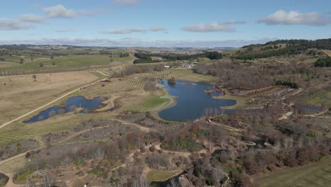 cinematic aerial view of a beautiful well maintained garden with water features, epic australian landscape at oberon, new south wales