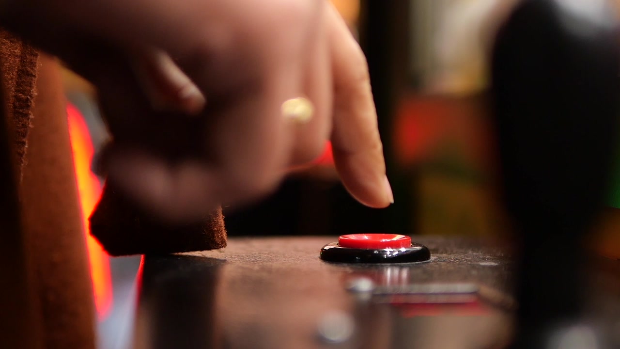 Close-Up of a Finger Pressing a Red Button on a Control Panel
