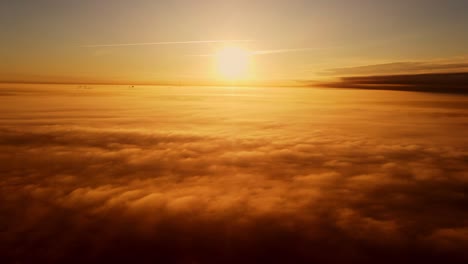 sun rises above endless clouds in warm amber hues, creating a tranquil horizon
