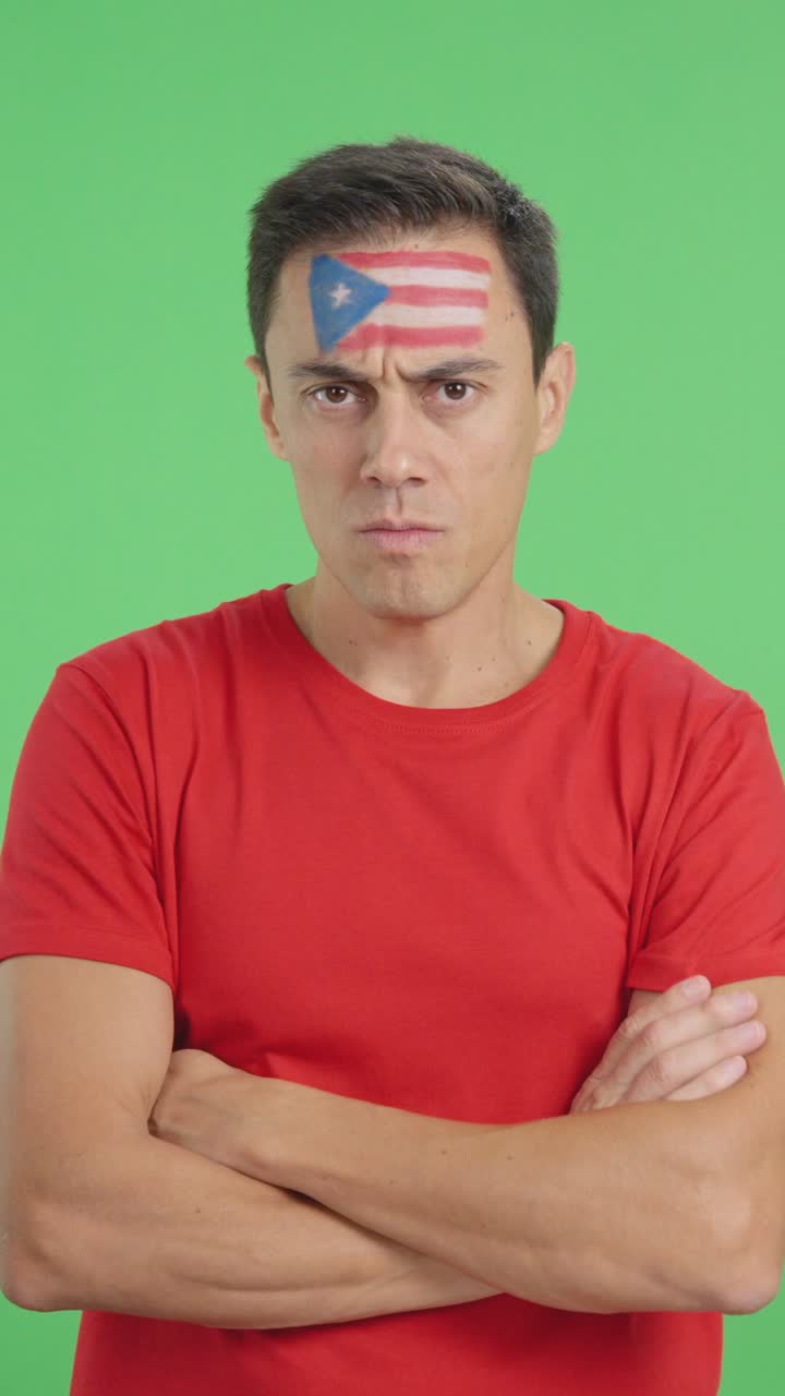 Dignified and serious man with puerto rican flag painted on face
