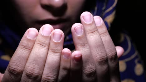 muslim women with head scarf praying, close up