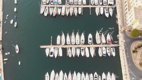 4k footage of a bird's-eye view of sailboats docked at a marina of the mediterranean island of malta