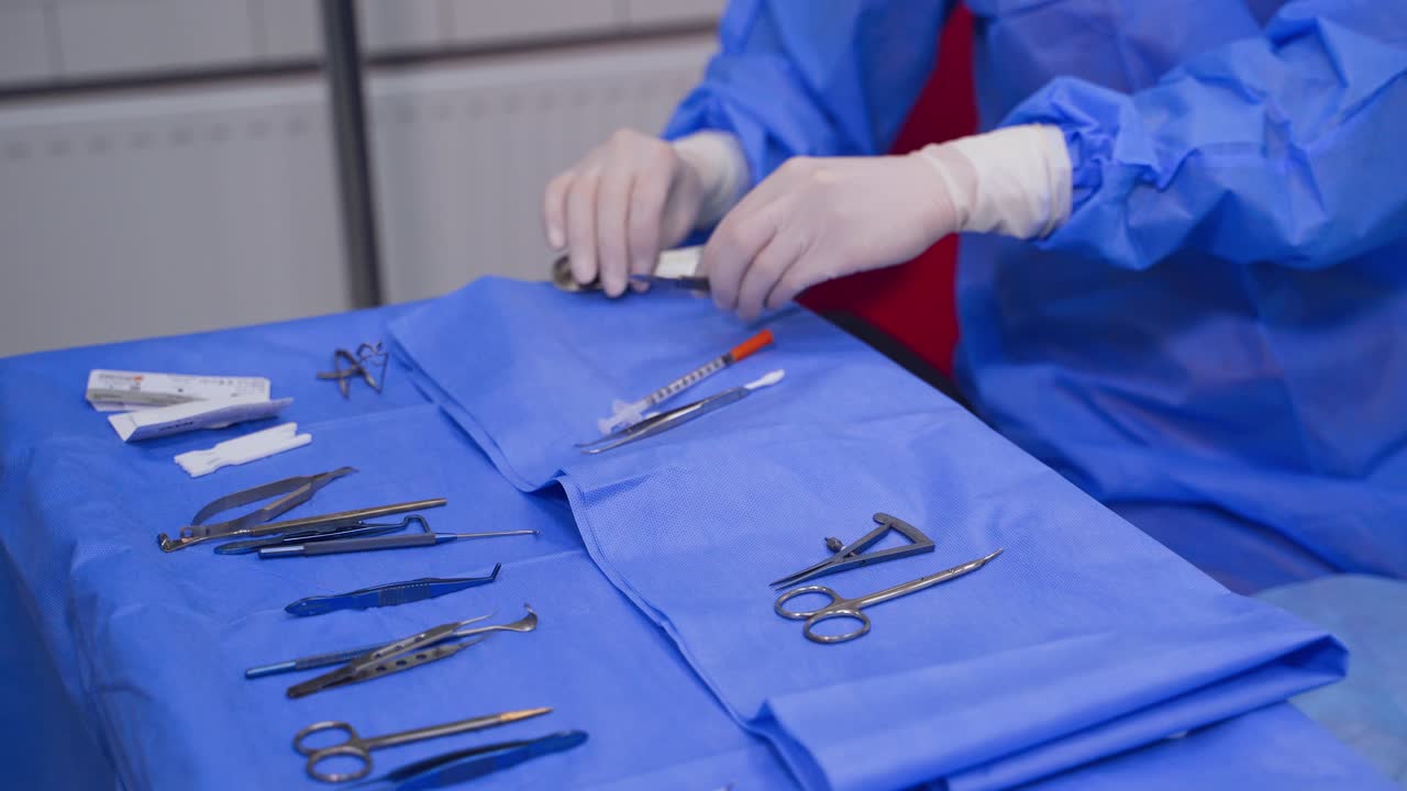 Medical instruments on the table. Doctor's hands taking necessary instruments during operation. Close-up.
