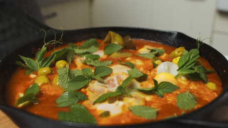 Plating-egg-and-vegetable-mix-baked-dish-with-greens-inside-frying-pan