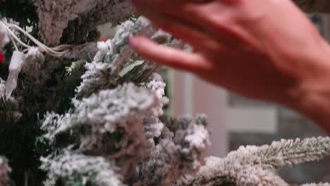 revealing shot of young woman decorate christmas tree