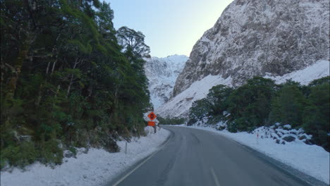 south island, new zealand - traveling along a road on a winter day in fiordland national park - pov