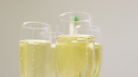 video of champagne in glasses on beige background