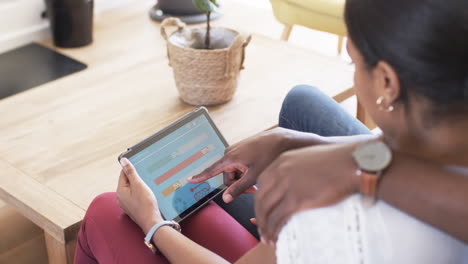 African-American-woman-examines-smart-home-app-energy-usage-on-a-tablet