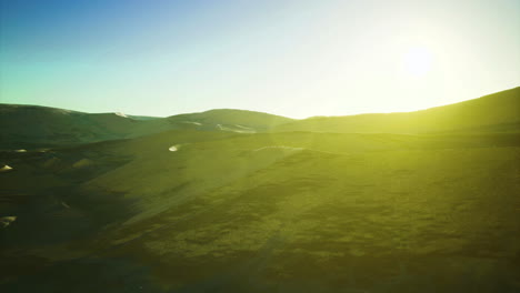 sunrise over desert hills creates a serene landscape in golden hues