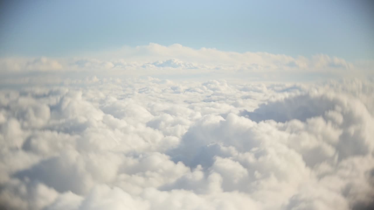 Flight over clouds, a view from a plane window - beautiful blue sky