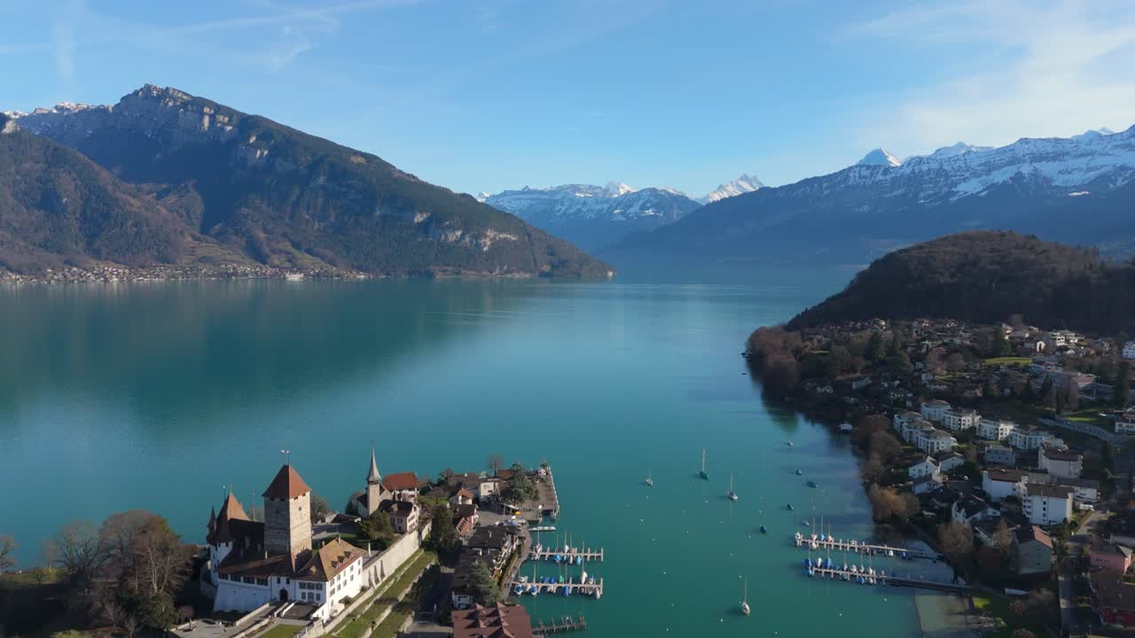 Spiez on Lake Thun with marina and Alps in background, clear skies, vibrant landscape