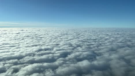 beautiful view from a jet cockpit overflying a blanket of clouds