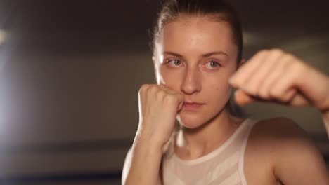 athletic woman practicing punches while training in the gym womens martial arts girl boxer practices punches professional womens boxing