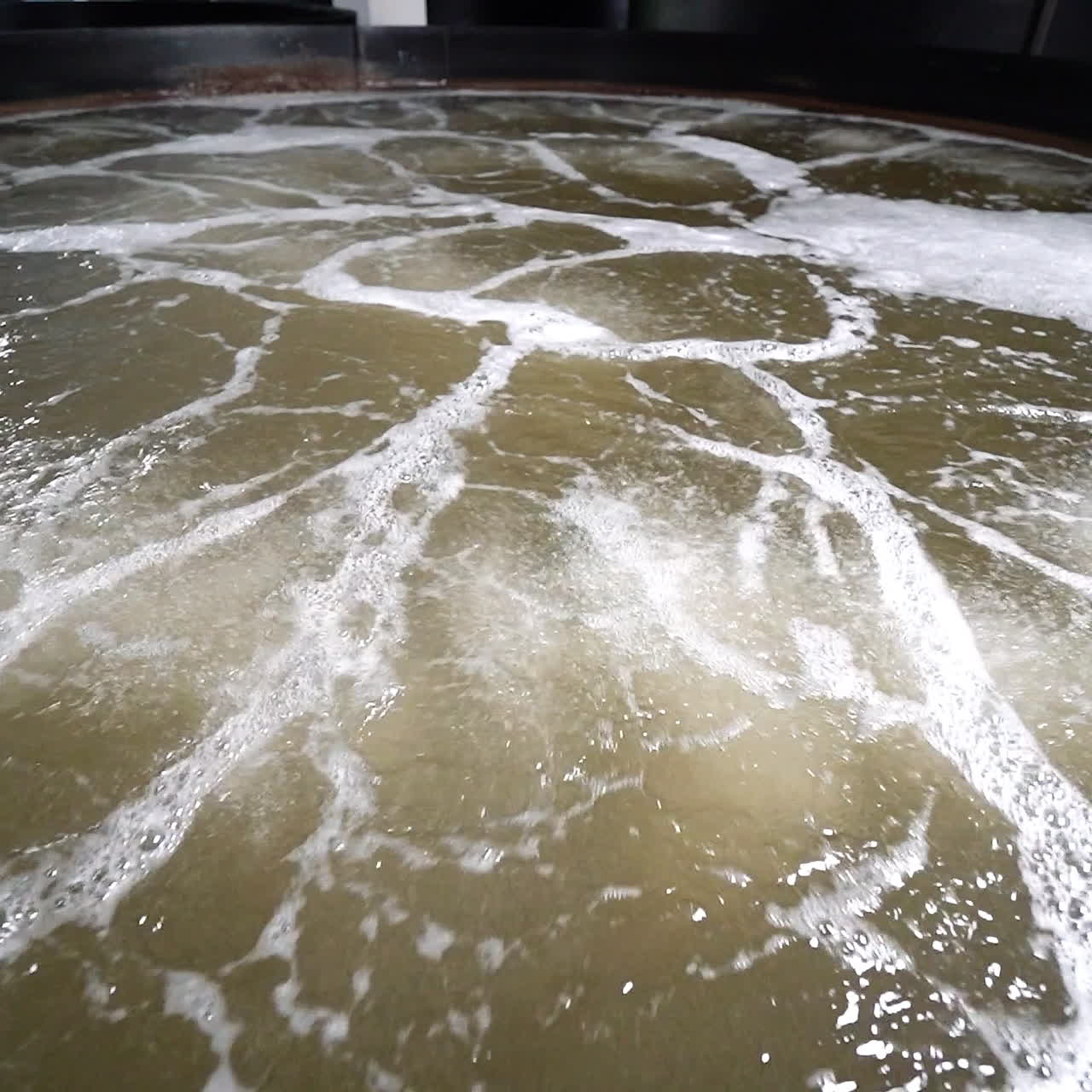 Close-up water on a shrimp farm inside. Shrimp farm pool with oxygen aeration system.