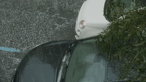 a car flashing its headlights during a hailstorm