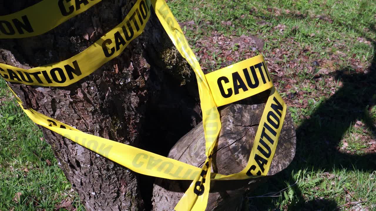 Warning for caution written on yellow ribbon