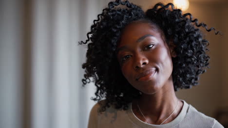 close-up portrait of a young black woman with curly hair