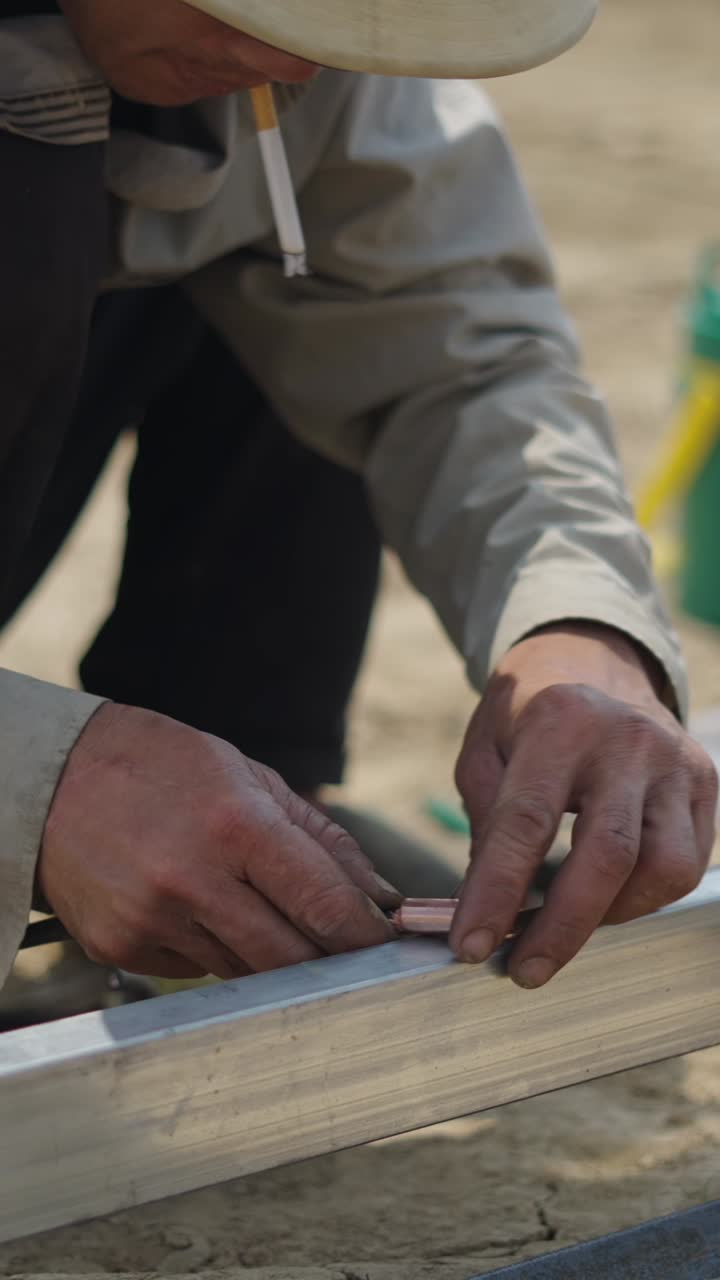Construction worker welding metal pipes