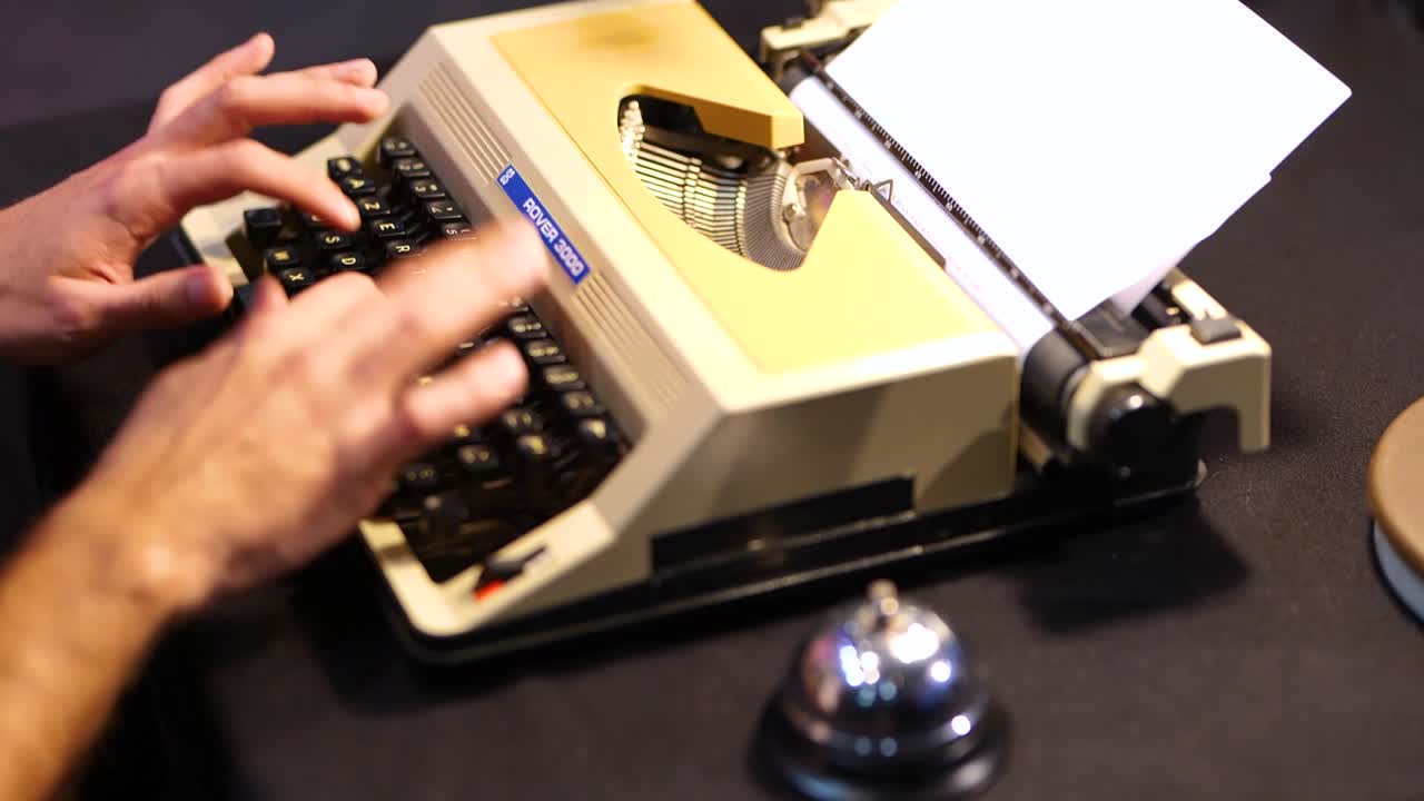 Person writing on a typewriter