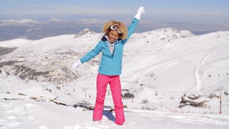 Single-woman-in-ski-clothes-waving-arms