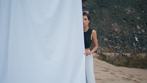 glamour girl resting beach shore. professional fashion model looking camera