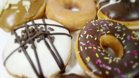 tracking over selection of iced doughnuts