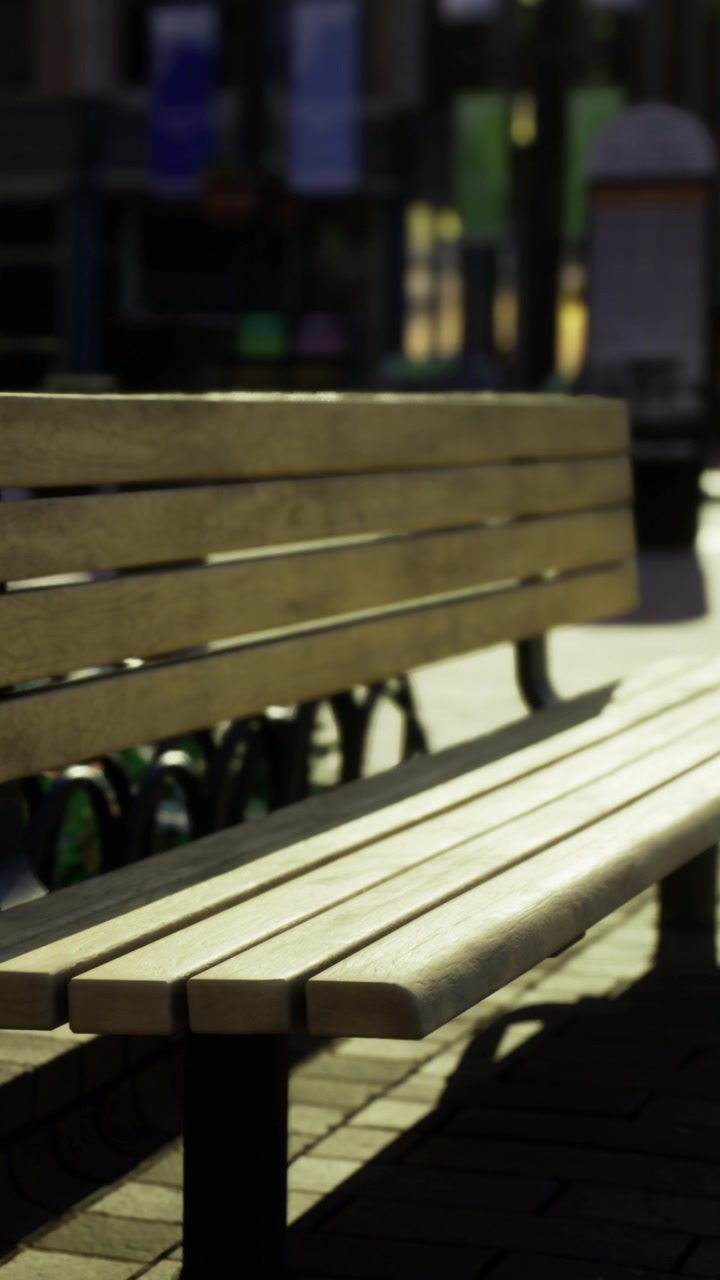 Wooden bench in urban setting during evening hours with soft light
