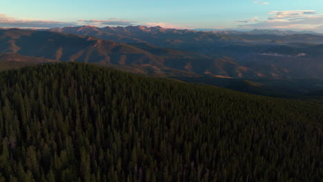 Cinematic-aerial-drone-sunrise-morning-Denver-front-range-foothills-Rocky-Mountains-layers-i70-Idaho-Springs-Evergreen-Mount-Evans-14er-wilderness-Squaw-pass-Echo-Mountain-dense-forest-forward-motion