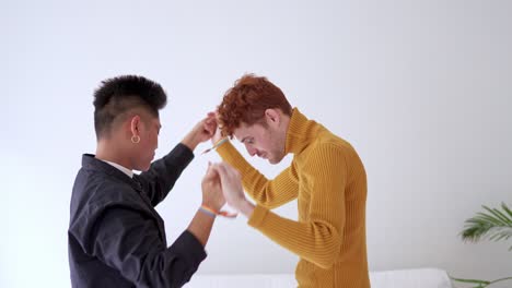 joyful lgbtq+ couple dancing and holding hands