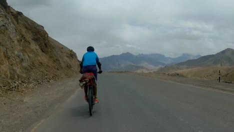 biker speeding on the mountain road to leh in ladakh, india - rolling shot