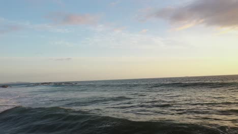 drone flyover of ocean as waves cresting