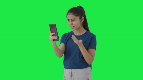 Angry-Indian-teenage-girl-shouting-on-someone-on-video-call-Green-screen