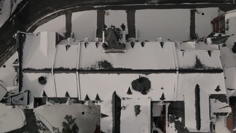 top view of bishops university mcgreer hall, roof covered with snow in winter - sherbrooke, quebec - drone pullback