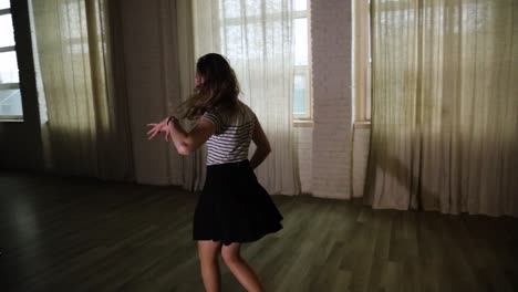 teenage girl spinning and dancing in the studio slow motion