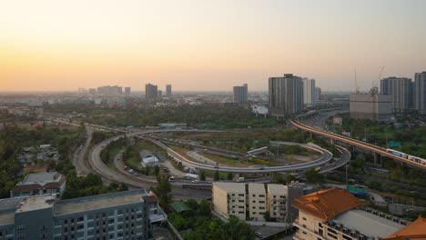 time lapse of aerial view of highway street road with cars traffic on railway, bangkok downtown. thailand. financial district in smart urban city.