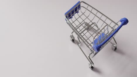 High-angle-view-of-empty-shopping-trolley-on-white-background-with-copy-space