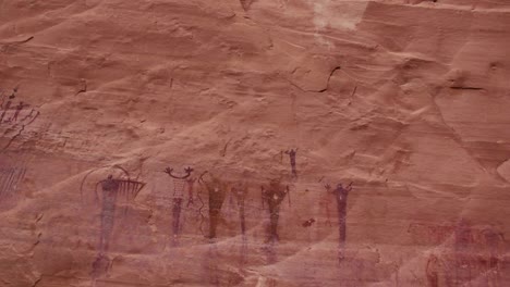 native american pictographs on a red rock wall in southern utah.
