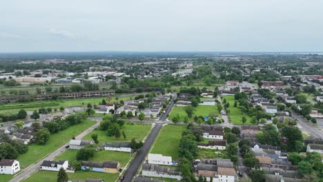 An-aerial-view-of-the-green-city-of-Buffalo,-New-York-with-storm-clouds-in-the-distance