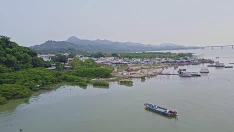 a dynamic aerial shot of the lake of the fishing village in lau fau shan in the new territories of hong kong