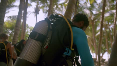 kenyan man at the beach preparing for scuba diving in kenya