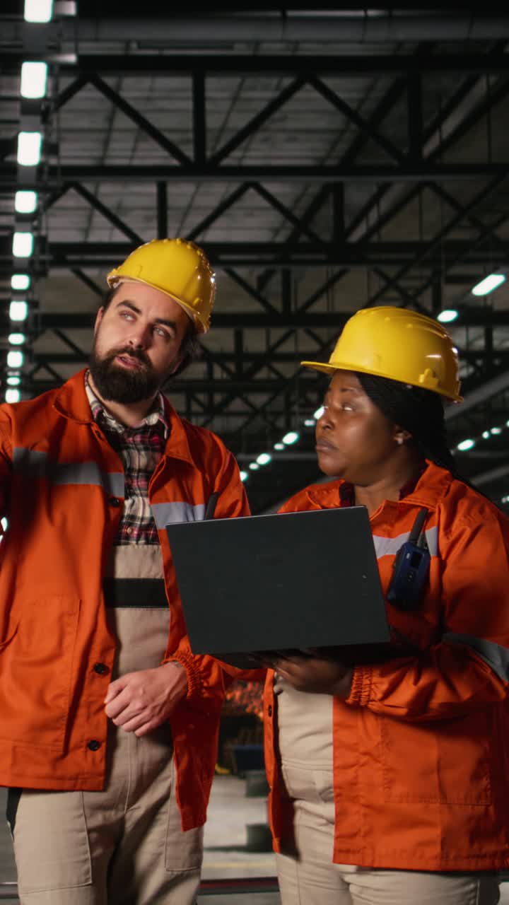Vertical Video Diverse engineers, using walkie-talkie, portable transceiver, heavy industry