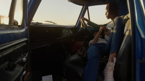 woman lying on mans lap in a pickup truck at beach 4k