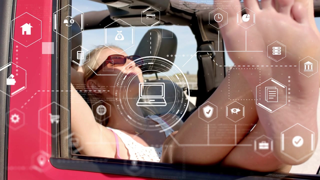 Vertical video: Adult female resting in red convertible on open road while HUD showing laptop