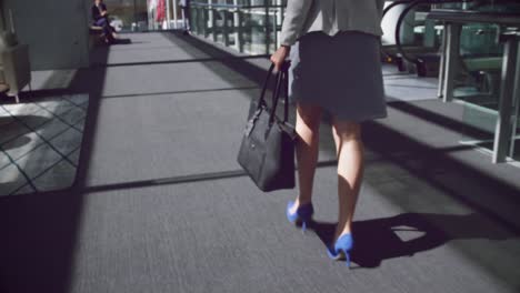 woman walking in the corridor at office 4k