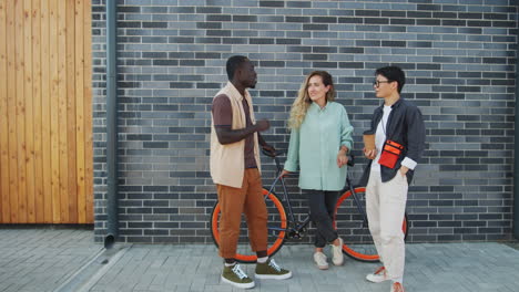 multiethnic friends chatting on city street