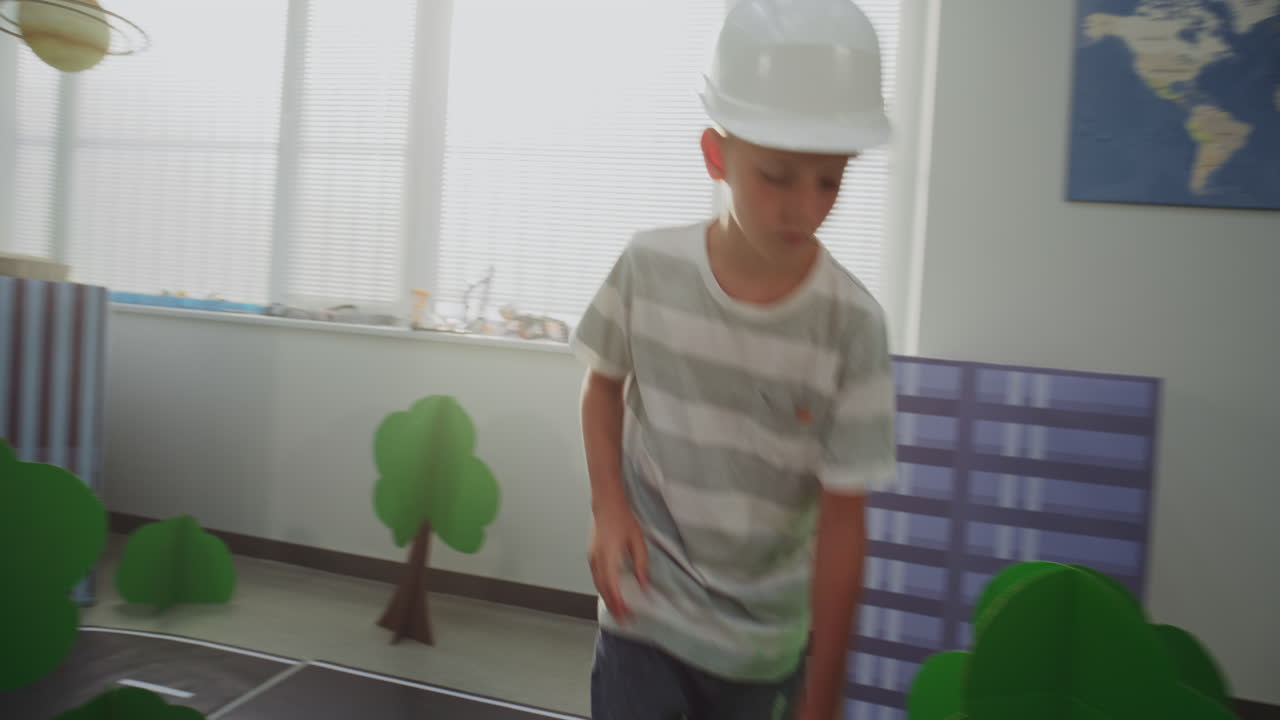 Team of Primary School Students in Hardhats Creating City Planning